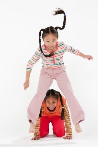 Two girls playing leap frog